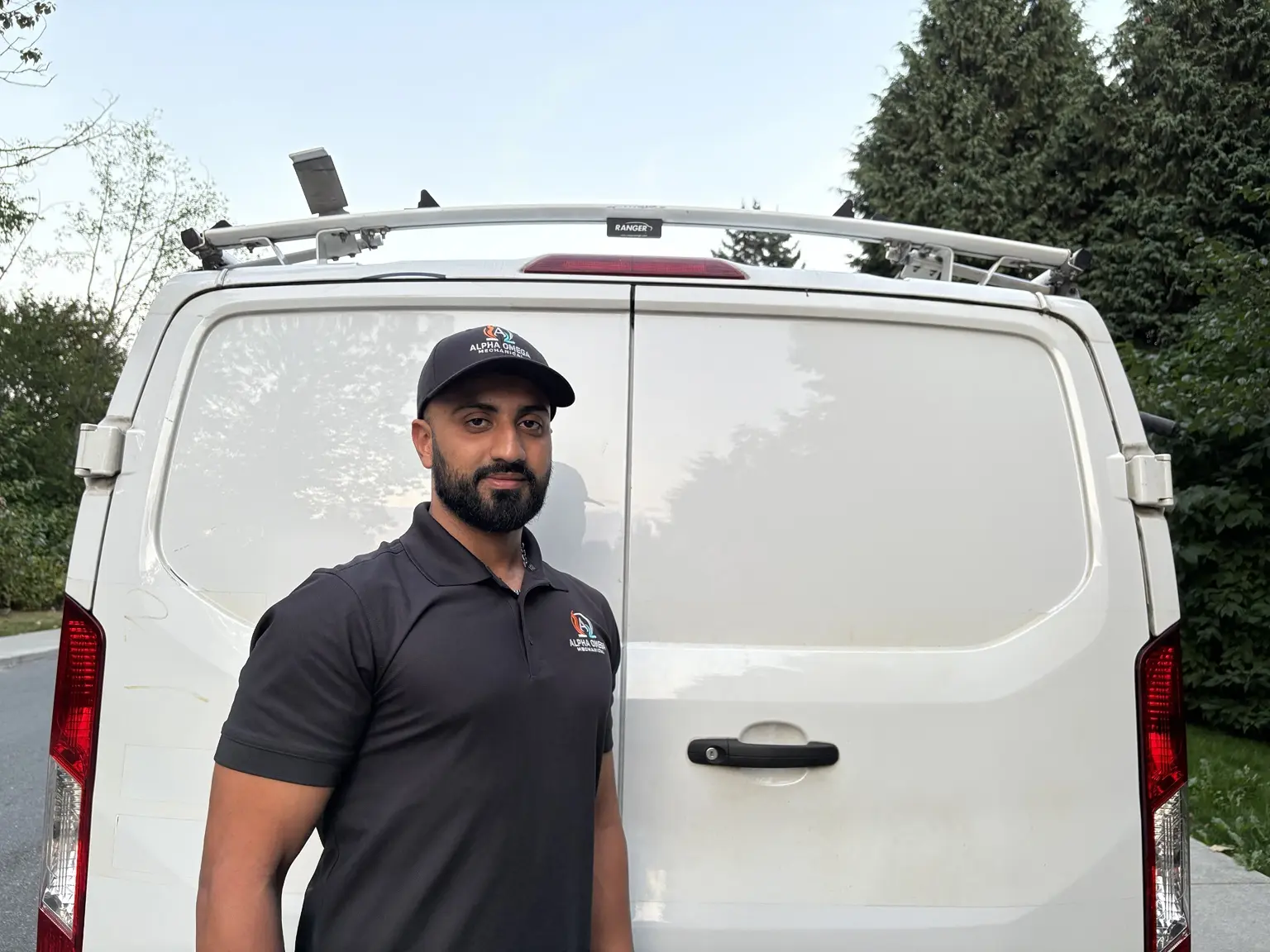 Hossein Shirzad of Alpha Omega Mechanical beside his service van in Port Coquitlam