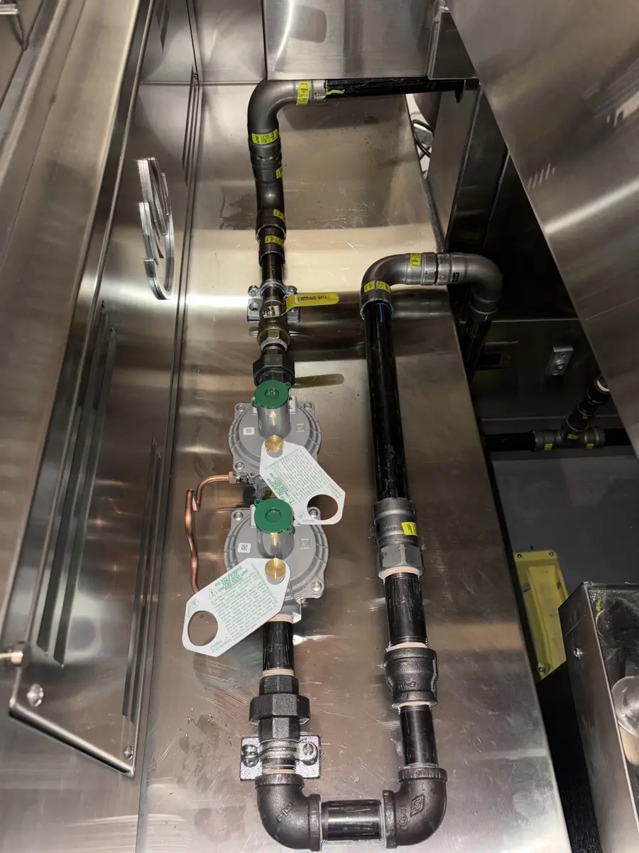 Regulators and finished gas manifold piping in a commercial kitchen