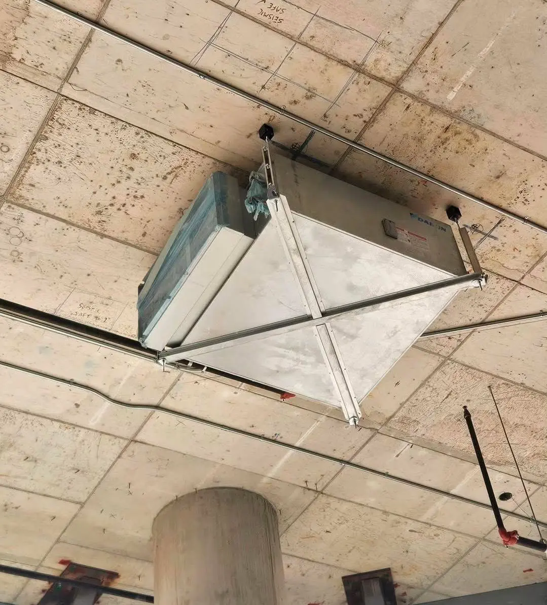 Suspended fan-coil unit installed in a commercial space
