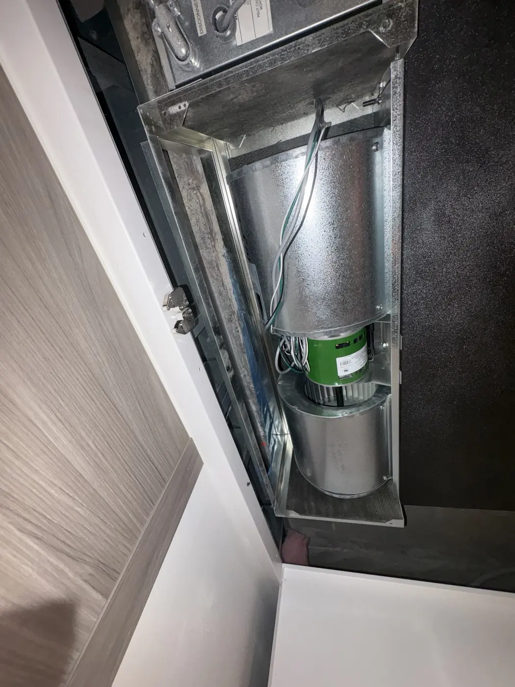 Replacement motor installed inside a horizontal heat-pump unit
