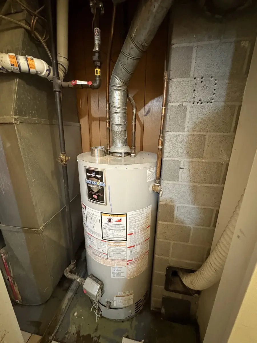 Burst natural-gas water heater before replacement in Vancouver